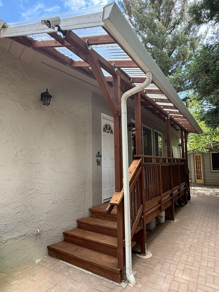 Deck construction — covered porch with stairs and railing