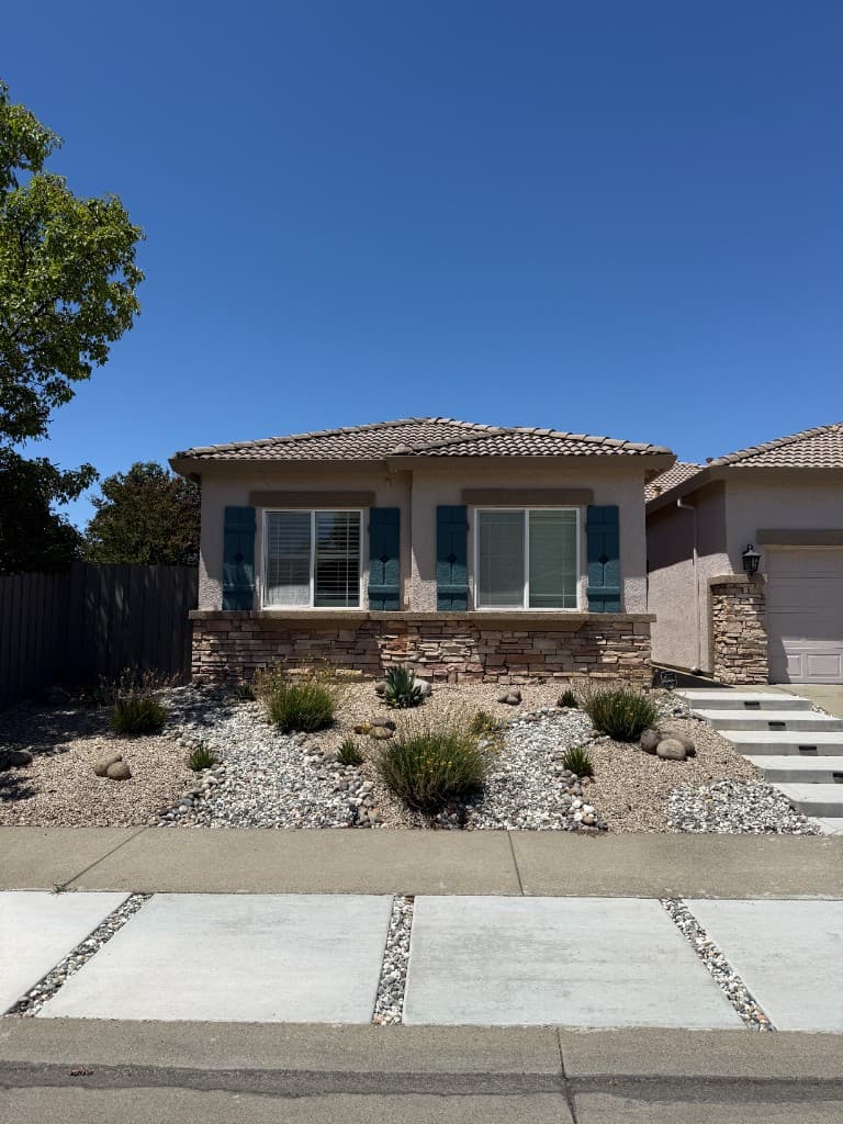 Landscaping and concrete — front yard with river rock and concrete walkway