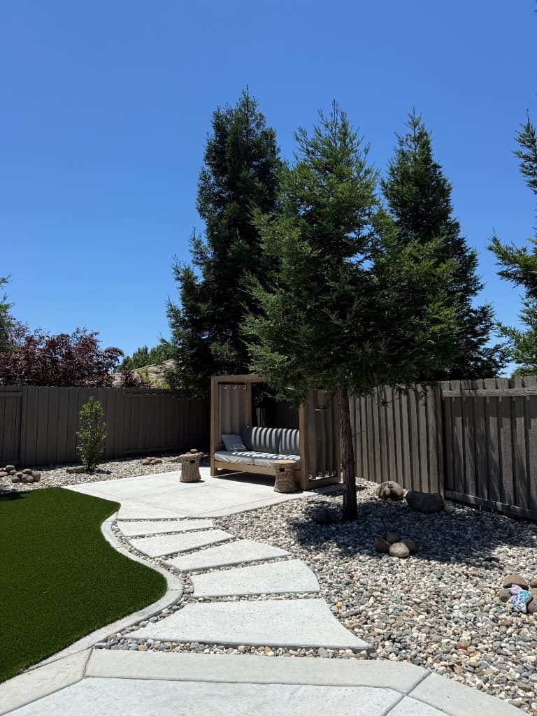 Landscaping and concrete — backyard with turf, patio, and stepping stones